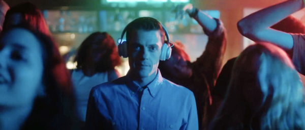 Movie magic: Conestoga alumnus Mark Elias, playing character Aaron Barnes, watches a band play a live show. He released “Boy Makes Girl” in 2022 after delays due to the COVID-19 pandemic. 
